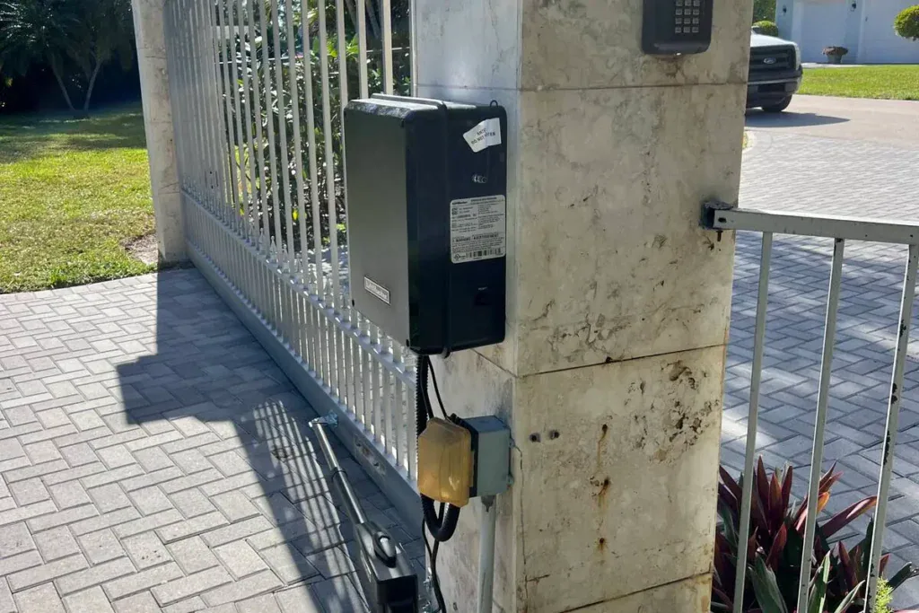 LiftMaster control box and swing-arm opener on a stone column in Coral Springs