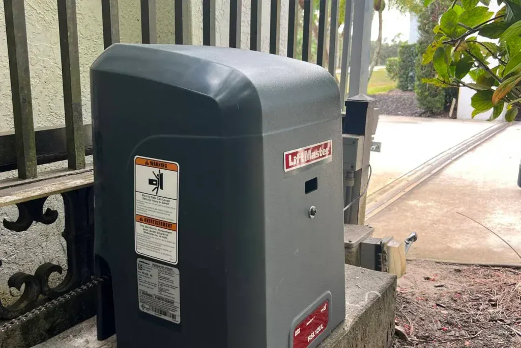 LiftMaster slide gate opener mounted beside a metal fence in Lauderhill