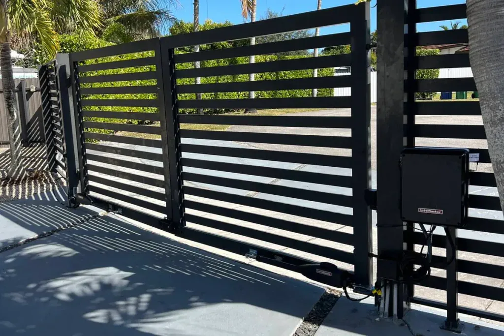 Black horizontal-slat aluminum gate with a LiftMaster opener in Miramar