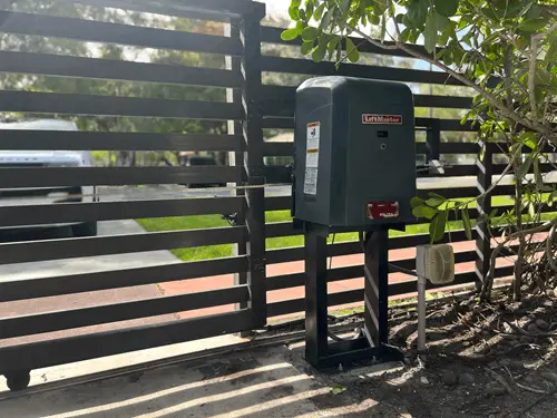 LiftMaster operator mounted on a post beside a slat gate